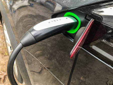 Godeffroy, NY, 09/22/2019: Tesla vehicle is being charged.