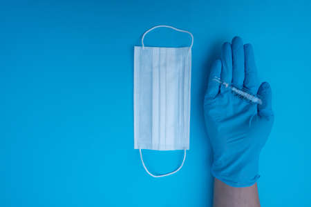 Doctor hand hold syringe in blue glove.の写真素材