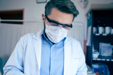 Young Scientist Checking Test Tubes In The Lab. Man Wears Protective Gogglesの写真素材