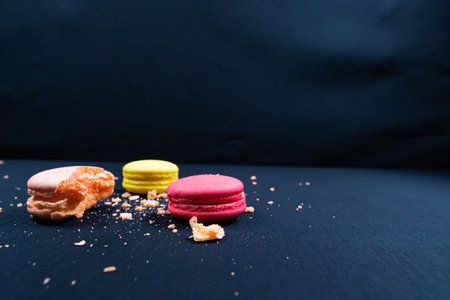 Colorful stack of macaroons isolated on plain black background. Copyspaceの写真素材