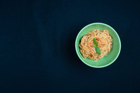 Chicken Schezwan Noodles or Hakka or Chow Mein in black bowl at dark background.の写真素材