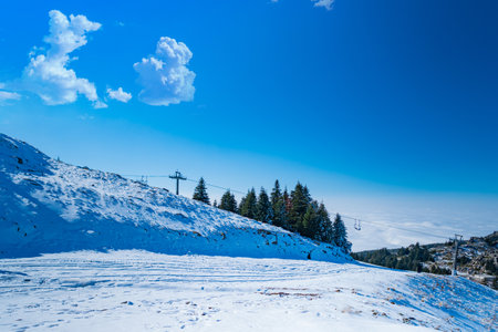 Man in the mountain photographing the mountain covered with snowの写真素材