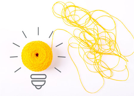 Inspiration concept yarn yellow light bulb metaphor for good idea. Symbol of idea as light bulb on...