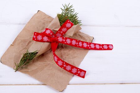 Christmas Background - fir branches tied with a red ribbon. kraft paperの写真素材
