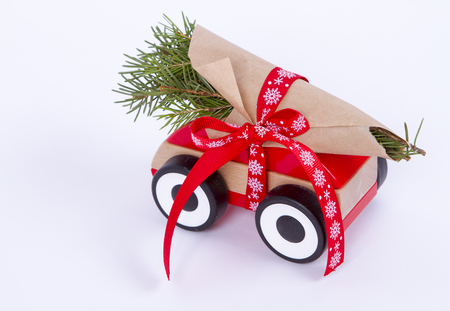 Christmas tree fir branches on toy car. tied with a red ribbon. Christmas holiday celebration conceptの写真素材