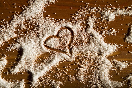 heart of sugar on a wooden background in sunlight. declaration of loveの写真素材