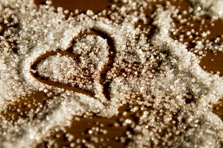 heart of sugar on a wooden background in sunlight. declaration of loveの写真素材