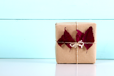 Handcrafted gift box and autumn leaf . presentの写真素材