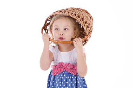 girl with blue eyes with a basket on her head. foolの写真素材