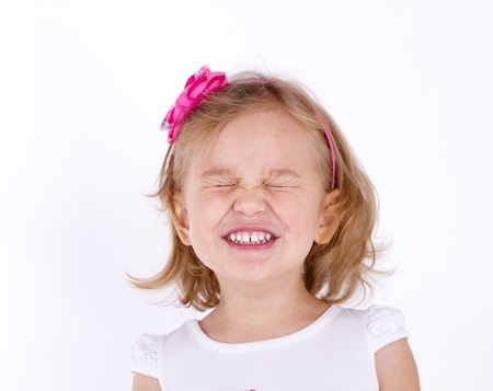 little girl close up strongly squeezed her eyes shutの写真素材