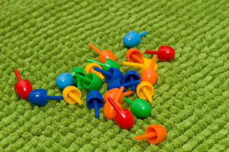 Details of children's plastic mosaic carpet on a green backgroundの写真素材