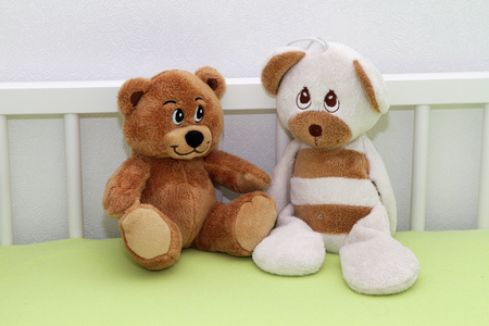 Two teddy bear sitting in the baby cotの写真素材