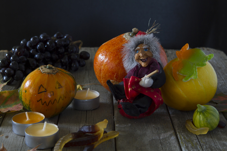 figure witch pumpkin with eyes jelly worms candles old wooden boards - the attributes of Halloweenの写真素材