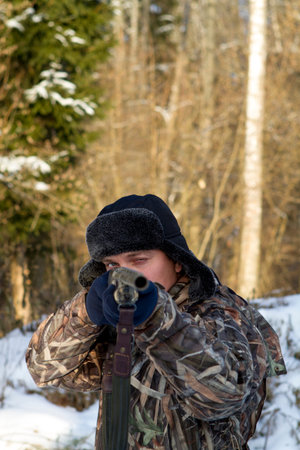 Hunter aiming the shot, sharpness on the eyes