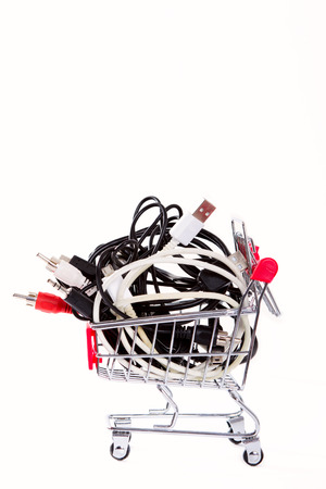 Little shopping cart filled with computer and other cablesの写真素材