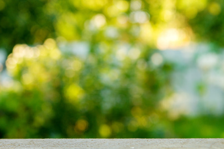Empty wood table over blurred trees with bokeh background, product display montageの写真素材