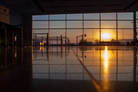 Silhouette of a airport at sunset, check-in counterの写真素材