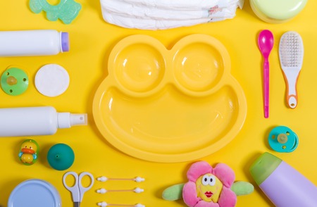 diapers. cream, scissors, jars, nipple, cotton buds. cotton wheels, toy, plastic spoon, hairbrush, teethers, rubber duck - all that is needed to care for the babyの写真素材