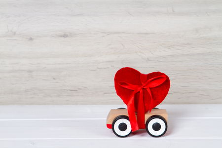 wooden toy car with red heartの写真素材