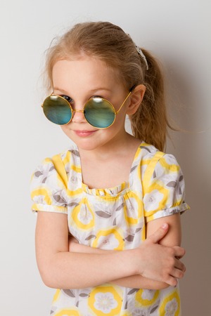 little girl in round sunglassesの写真素材