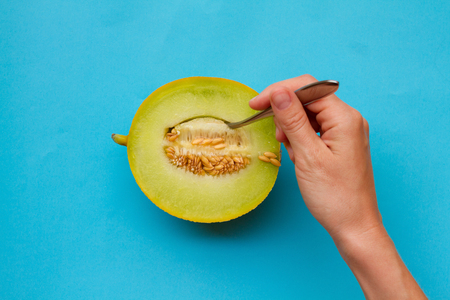 Melon Top view Half of ripe melon is lying on a table Photo in minimalist style with copy spaceの写真素材