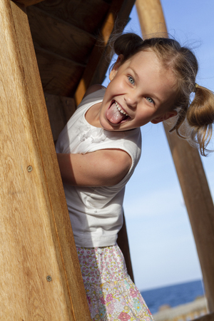 child girl playing in the playground in parkの写真素材