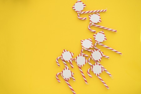 A lot of christmas candies on yellow backgroundの写真素材