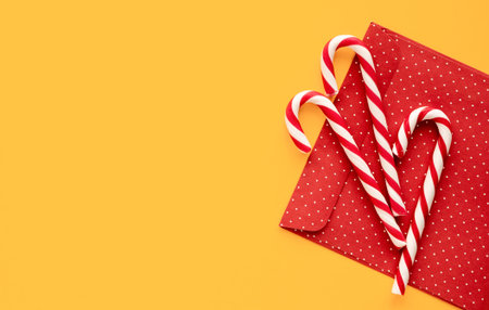 Christmas mint candies on yellow  with gift envelope