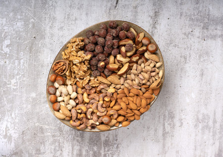 top view of assorted different types of nuts on a plate