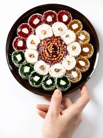 Turkish delight Turkish sweets on a plastic plate, on a white background.の写真素材