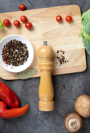 Pepper and pepper mill. Spices Top view. On an old background.. Lies on the table. Nearby peppers in white cups. kitchen background. view from above.の写真素材