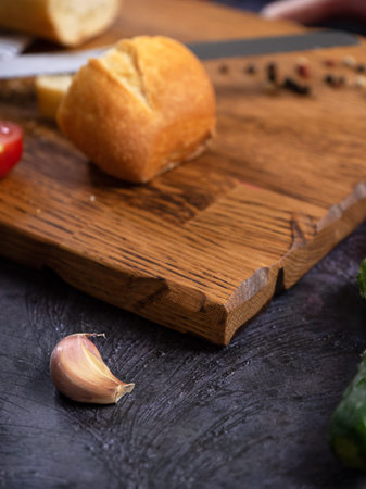 Wooden cutting board, linen textile and cutlery. Food background with copy space. Table top view