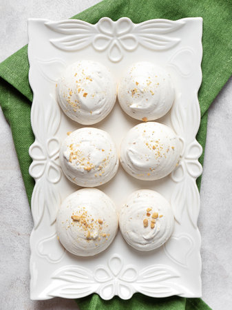 top view of a rectangular, carved plate with round walnut meringues on it.ular. carved plate with round walnut meringues on it.の写真素材
