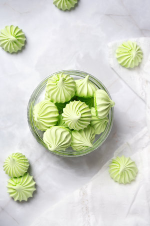 Green-light green French dessert Meringue of beaten with sugar and baked eggs. Cup of homemade meringueの写真素材