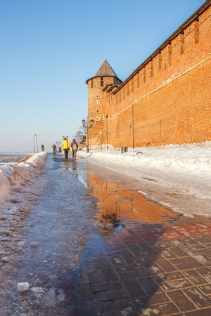 The northern tower of Nizhny Novgorod reflected in a puddle in the springの写真素材