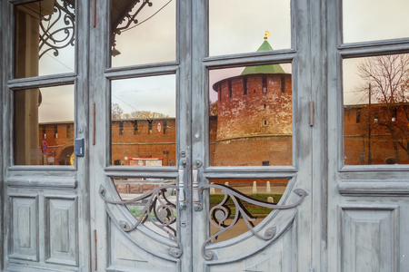 Reflection of the Kladno Tower of the Kremlin in the door of the Palace of Labor in Nizhny Novgorod in the autumnの写真素材
