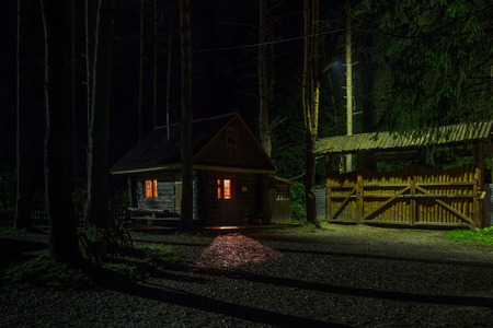 Light from the house window on the walkway at nightの写真素材