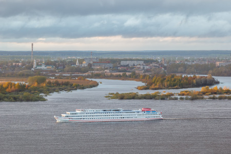 The passenger steam-ship goes along the Volga in the background of Bor town in Nizhny Novgorod regionの写真素材