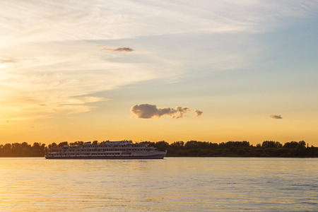 Three-deck passenger passenger ship at sunset on the Volgaの写真素材