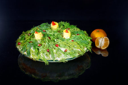 New Year's salad garnished with greenery, like branches of a Christmas tree, with candles made of cheeseの写真素材