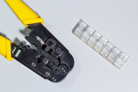 Connectors and tool for crimping of internet cable on white background