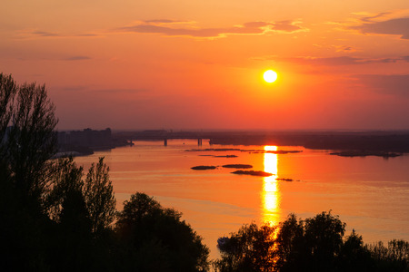 Beautiful sunset over the river and the bridge in Nizhny Novgorod, Russiaの写真素材