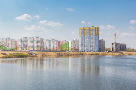 Residential buildings with reflection on the lake in the cityの写真素材