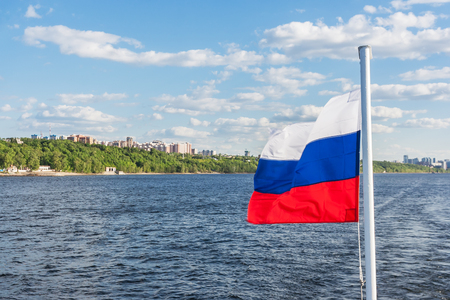 Russian flag on the background of the Volga River and the city of Samara at sunny dayの写真素材