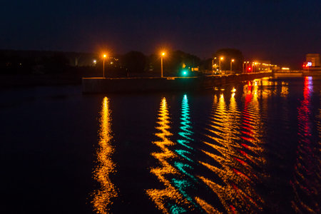 Bright reflection of lanterns in the river at night