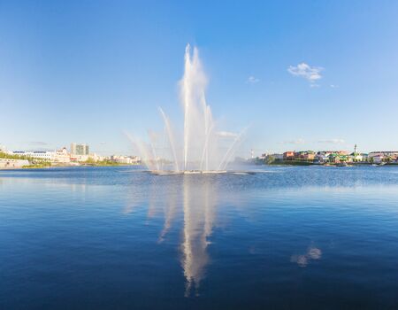 Fountain on the Lower Kaban Lake in Kazan with reflectionの写真素材