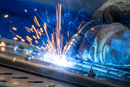 Bright welding sparks on a blue background