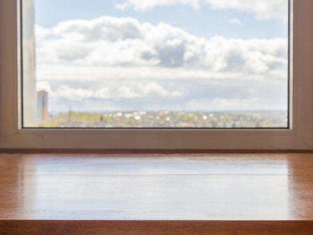 Window with a wooden window sill and landscape in it