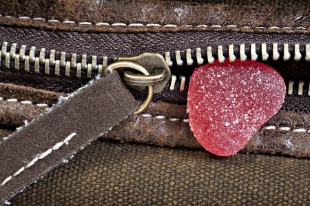 Red jelly sweet in a heart shape in pocket with zipperの写真素材