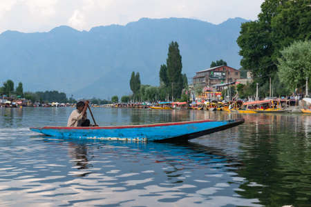 SRINAGAR, INDIA 21 - JULY, 2018 : Lifestyle in Dal lake, local people use shikara boat, a small boat for transportation in the lake of Srinagar, Jammu and Kashmir state, Indiaのeditorial素材